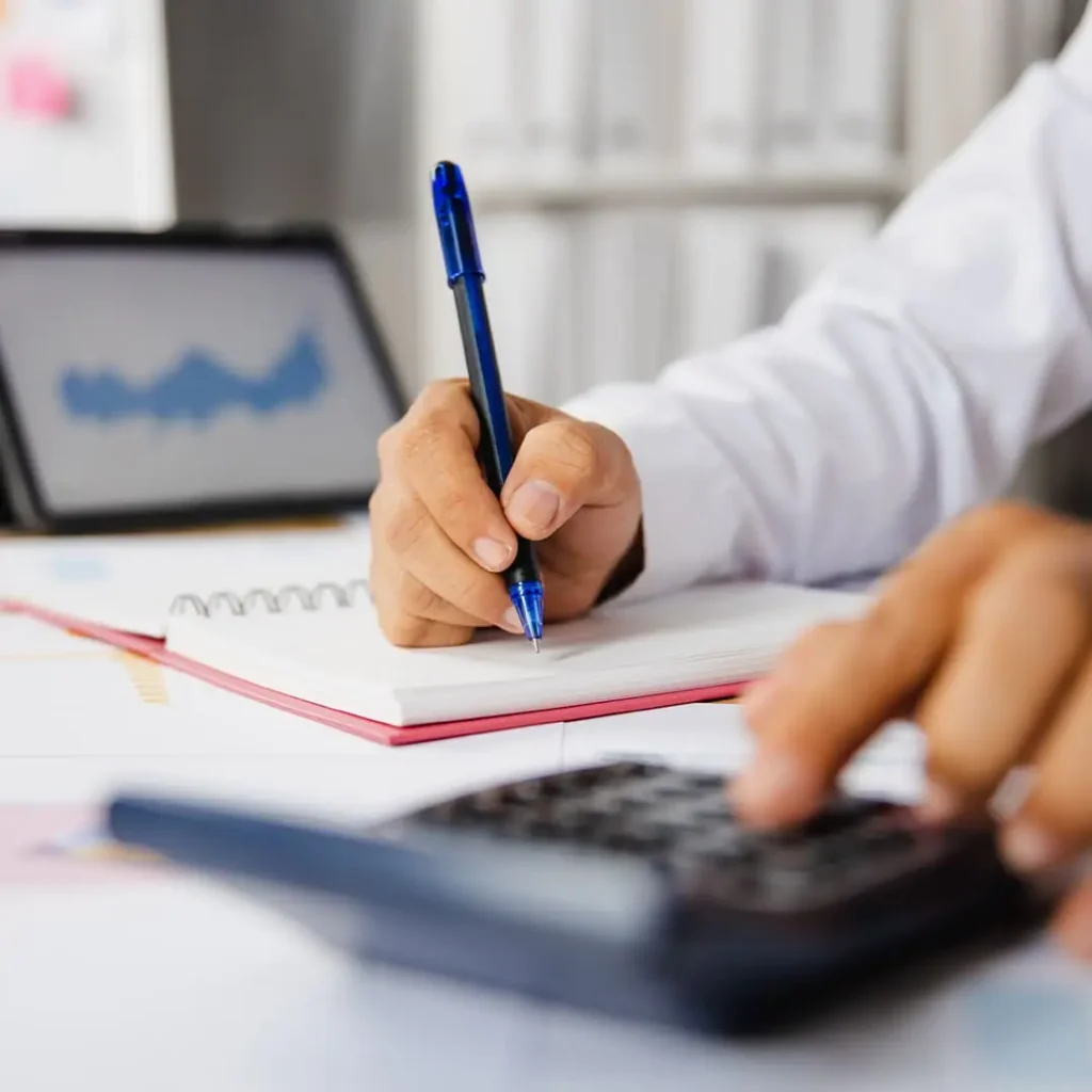 Prise de notes à côté d’une calculatrice